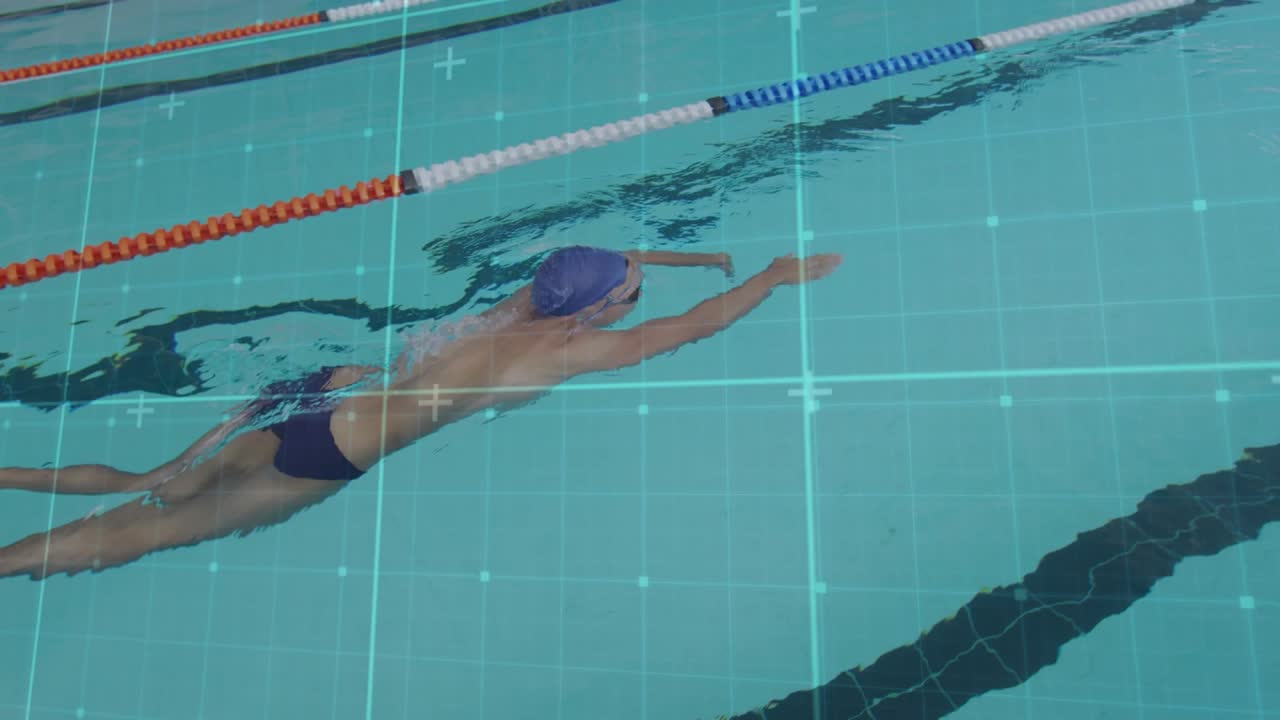 Gliding male swimmer wearing blue swim cap and dark briefs in lap lane with lane ropes