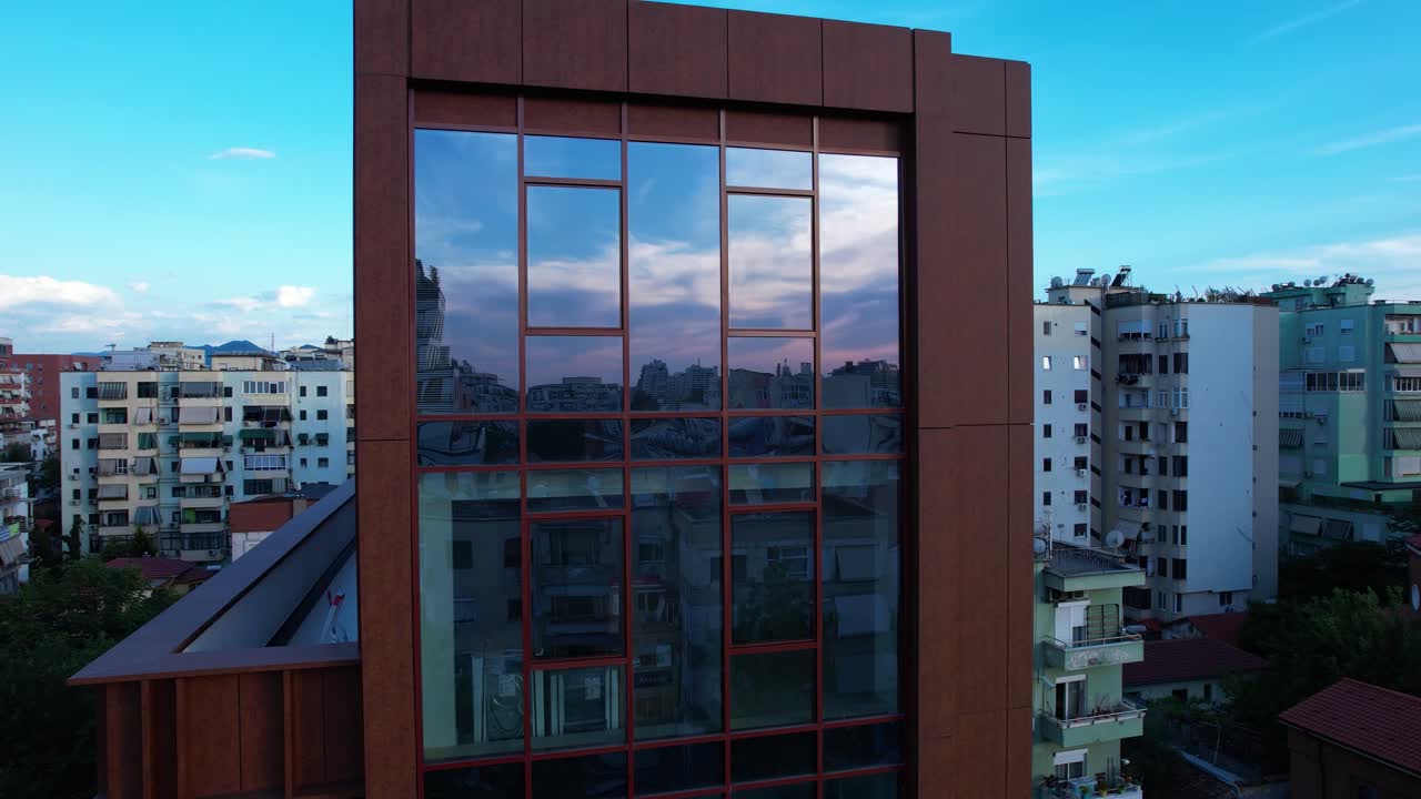 Mixed architecture in neighborhood of Tirana with new and old buildings, mirror glass facades, modern offices