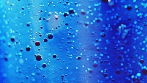 macro shot of little ink bubbles floating in sparkling water