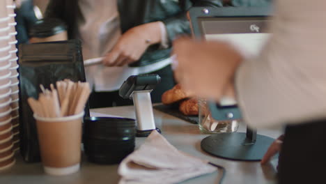 close up customer paying using smartphone buying coffee in cafe happy customer enjoying service spending money at restaurant