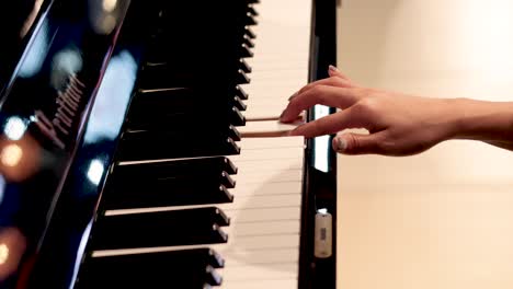 hands gracefully playing notes on a piano