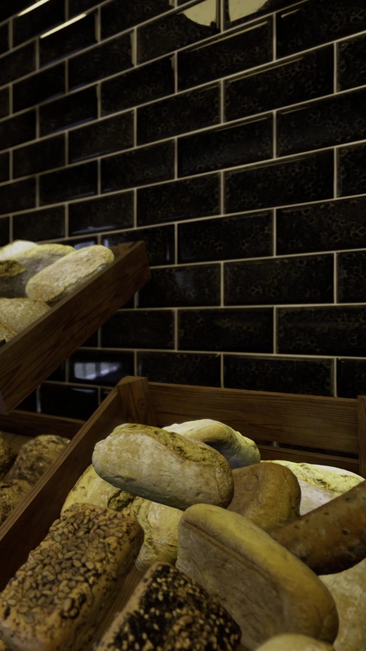 Selection of different types of bread on display in bakery at night