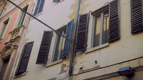old italian building with wooden shutters