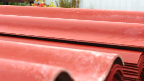 stacked red corrugated roofing material