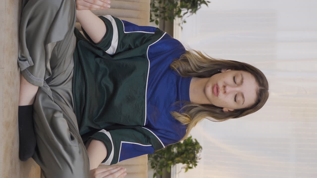 Vertical video of The meditating young woman.