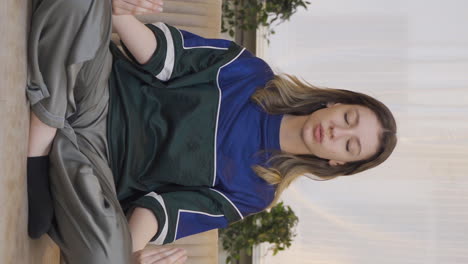 Vertical-video-of-The-meditating-young-woman.