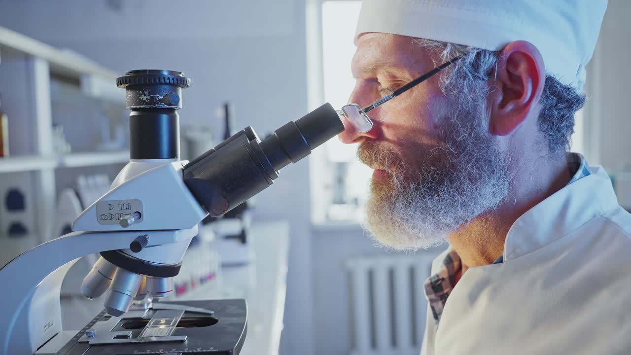 Male Scientist Working with Microscope in a Laboratory