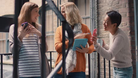 friends hanging out on stairwell using smart phone technology