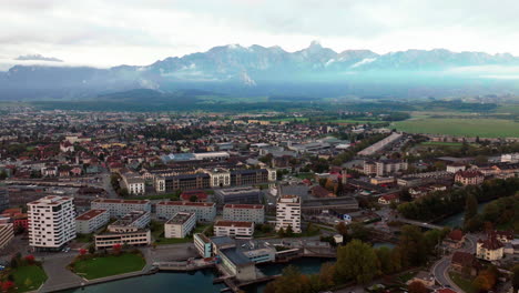 aerial cinematic drone early cloudy morning thun switzerland swiss lake river downtown city village bern interlocken view of stockhorn stockhornkette sunrise backwards slowly movement