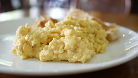 fried eggs mixed with bread on plate ,