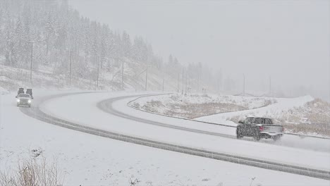 a pickup truck navigating the snowy roads of british columbia during a winter storm
