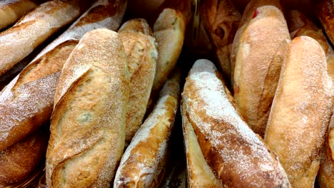 bread, buns and other bakery products of golden color on store shelves in motion