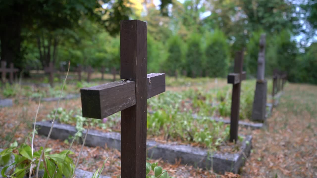 Close up of cross on war grave between other soldiers who passed away in war