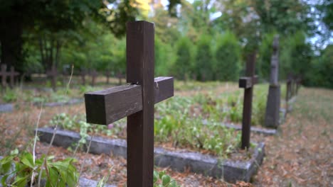close up of cross on war grave between other soldiers who passed away in war