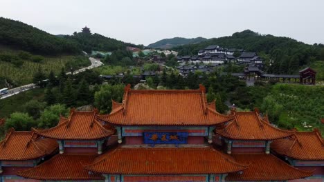 Aerial-dolly-forward-shot-of-the-Traditional-chinese-roof-at-huaxiacheng-gate-in-china-with-a-view-of-beautiful-chinese-landscape