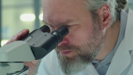 Senior Man Working with Microscope