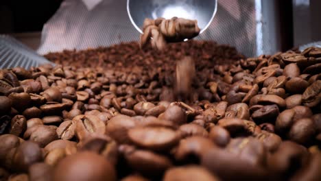 Close-up-of-seeds-of-coffee.-Fragrant-coffee-beans-are-roasted-smoke-comes-from-coffee-beans.