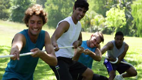 men pulling a rope in a tug of war