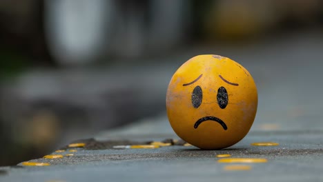 sad emoji painted on an egg