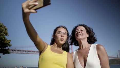 happy women taking selfie in park