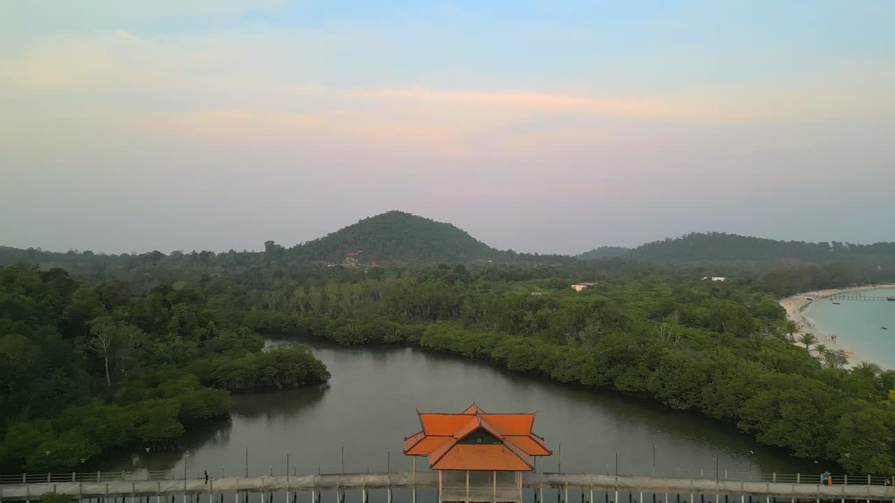 A bridge located on a tropical island contects the beach with the jungle.