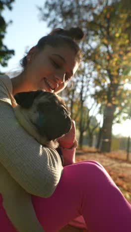 girl hugging a puppy in the park