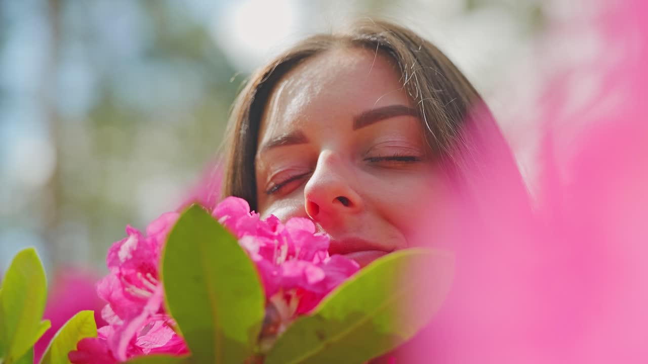 Close-up of a calm woman among vivid blossoms - symbolizes peace and renewal
