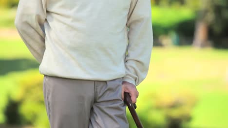 Mature-man-thinking-while-holding-his-walking-stick