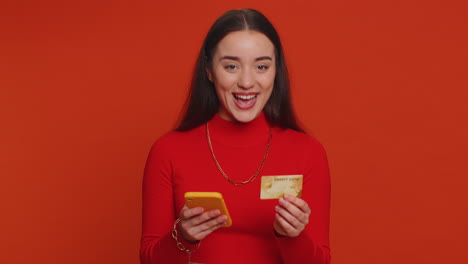 young woman using credit bank card and smartphone while transferring money purchases online shopping