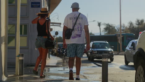 girl-and-guy-walking-down-the-wet-street