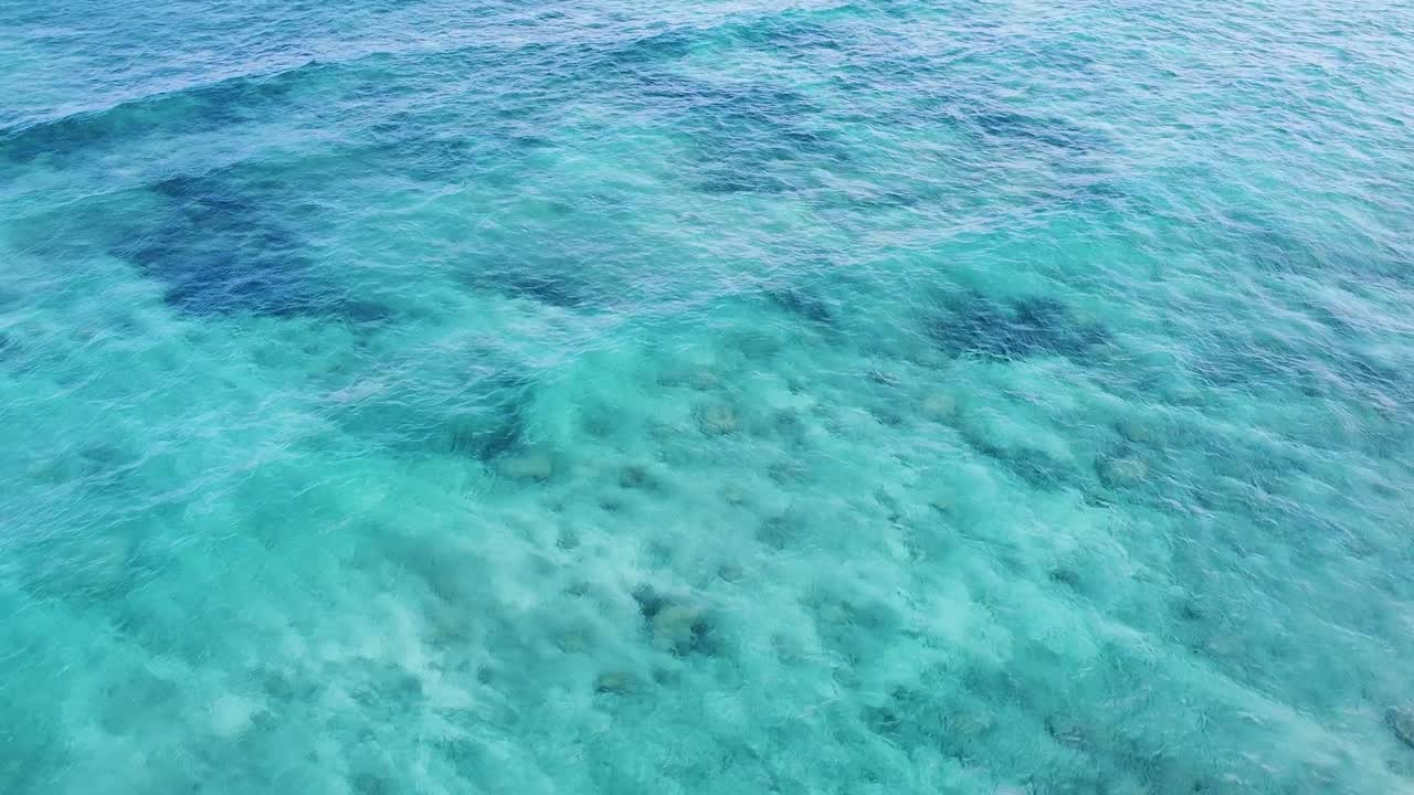Aerial seascape view over turquoise ocean water with rolling waves on tropical island of Timor-Leste, Southeast Asia