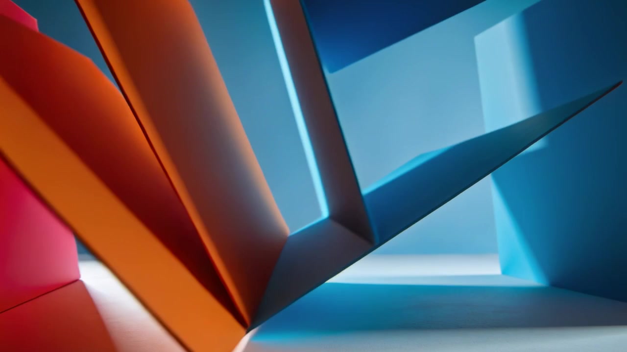 Panoramica della telecamera che rivela pieghe arancioni, rosa e blu su un tavolo chiaro, con le pieghe che ruotano per enfatizzare la geometria.