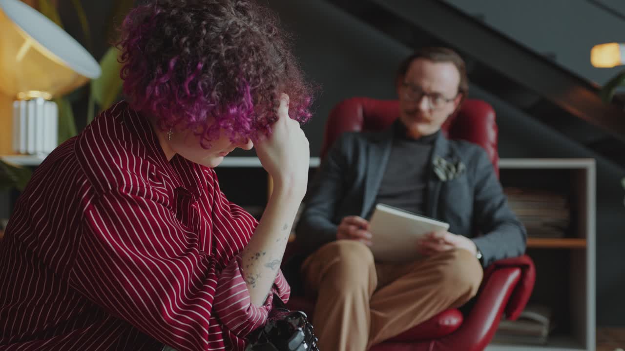 Girl with Prosthetic Arm Speaking with Psychologist during Counseling Session