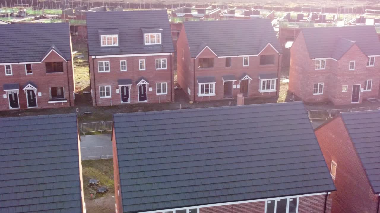 vista aérea del sitio de construcción del desarrollo inmobiliario de la casa adosada británica abandonada iluminada por el sol