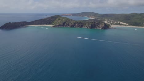 boats sailing across butterfish bay near secret beach in great keppel island, queensland