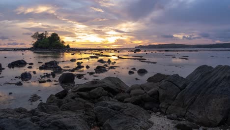 dramatic sunset over a rocky tropical shore