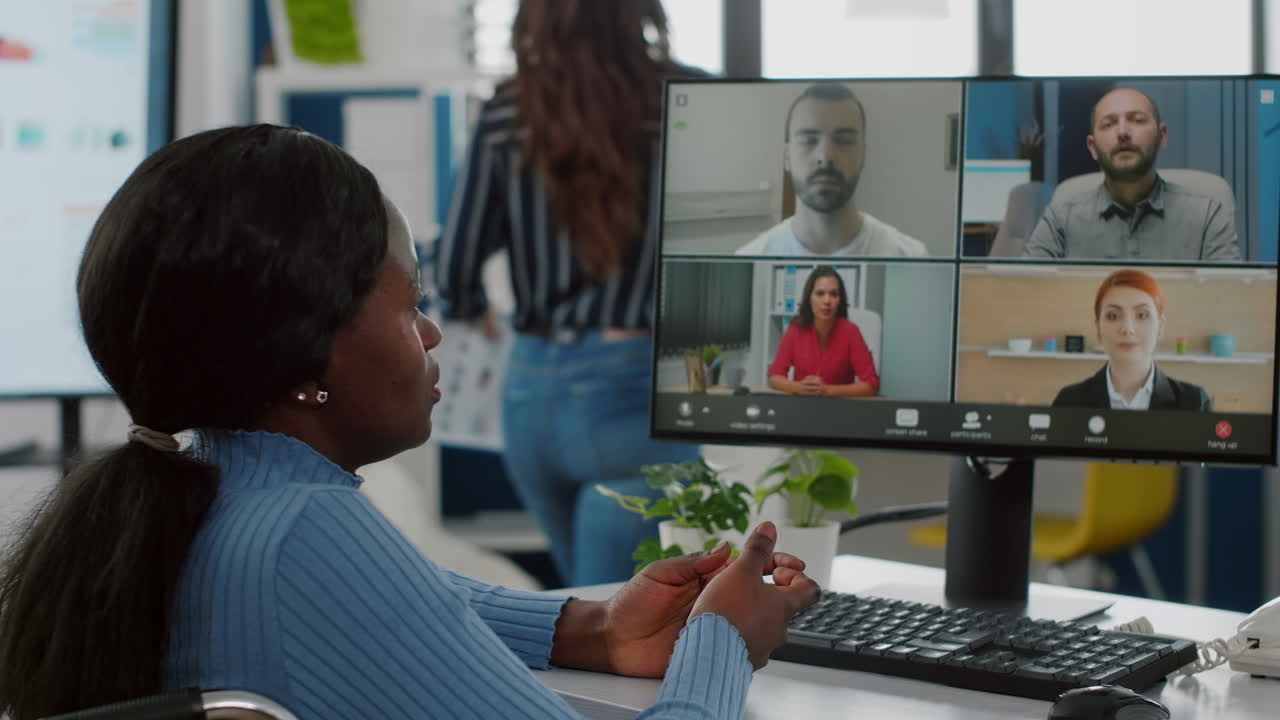 Immobilized black project manager in wheelchair talking on videocall