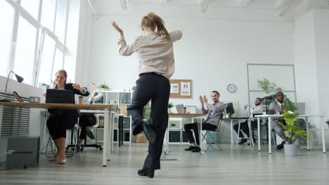 happy team celebrating in modern office