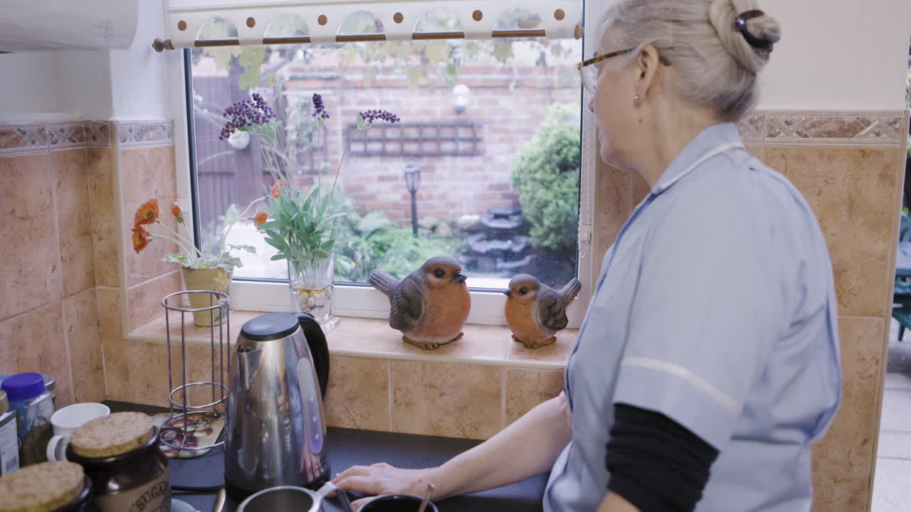 A woman stands in a kitchen