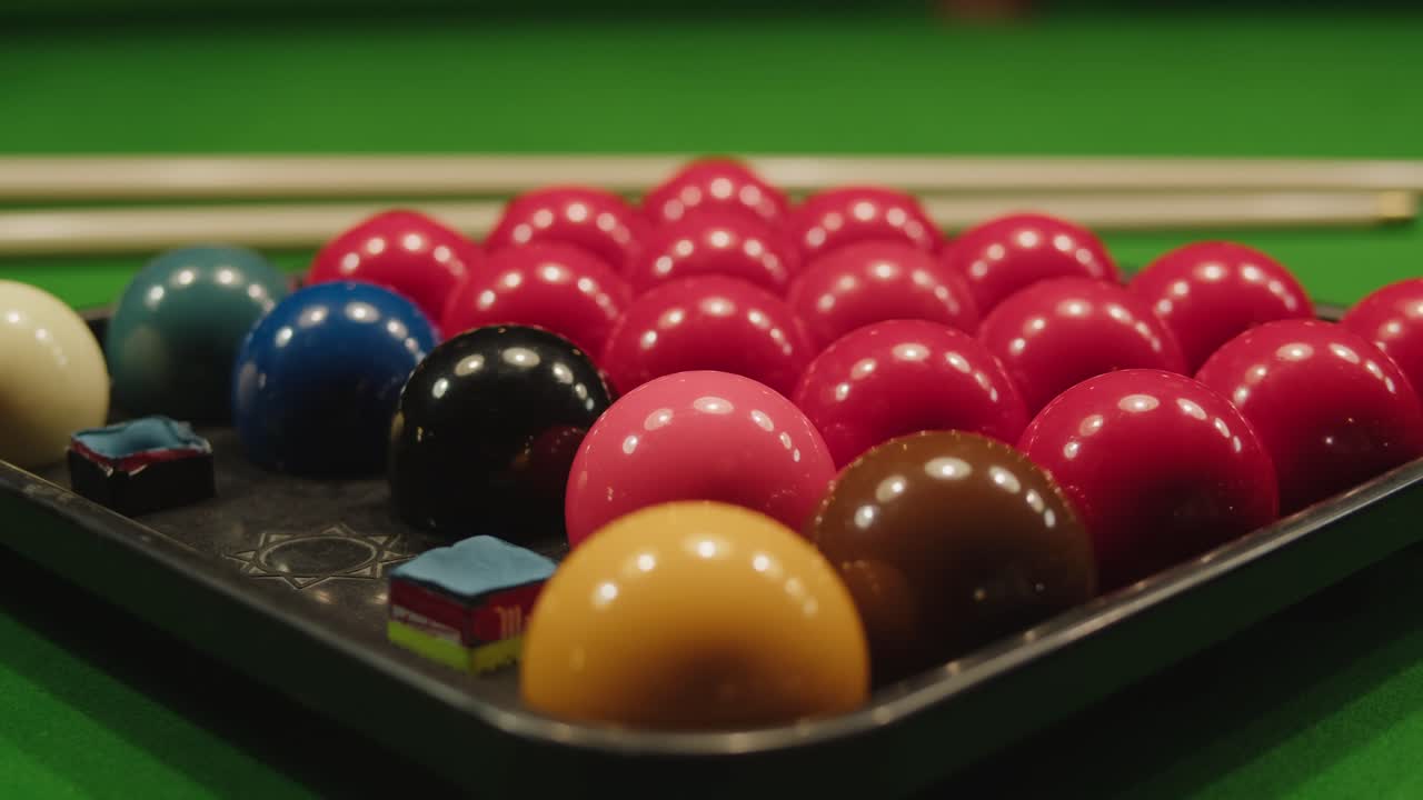 Snooker colorful balls close-up on green billiards table for start to play. Snooker game. Billiard balls with numbers on a pool table. Billiards team sport.High quality 4k footage
