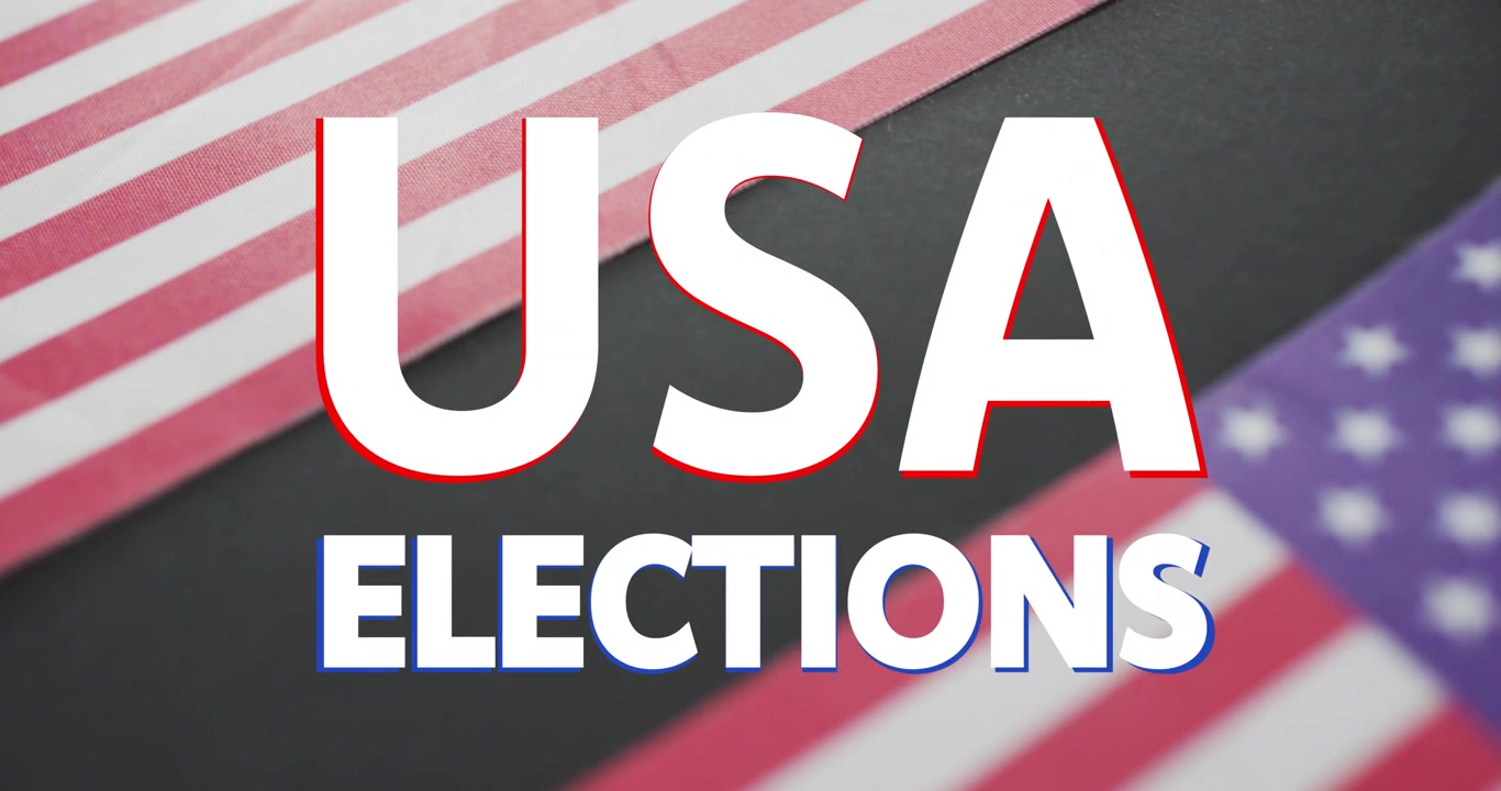 Nahaufnahme: Eine gefaltete US-Flagge wird geöffnet, der USA-Titel skaliert und verschiebt sich, der Buchstabe A bewegt sich, die Wahl wird betont.