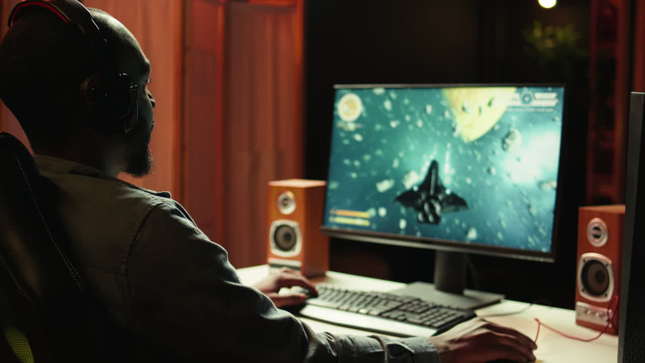 Close up of person enjoying galaxy flying game on computer monitor