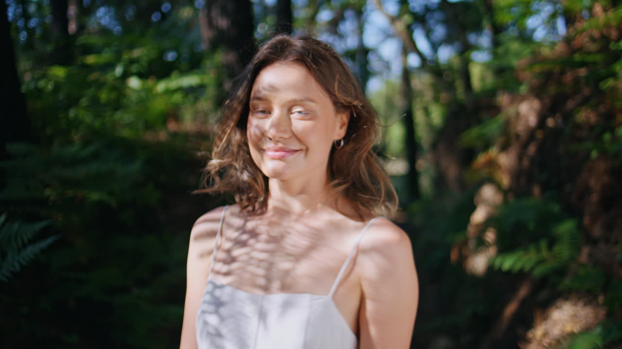 Gentle lady basking sunshine closing eyes serene expression at nature portrait