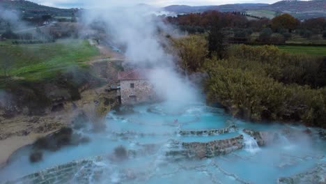 famous travel destination saturnia, geothermal hot springs bath and waterfall in tuscany italy close to siena and grosseto