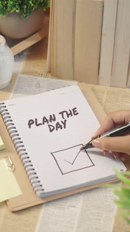 vertical video of ticking off plan the day work from checklist