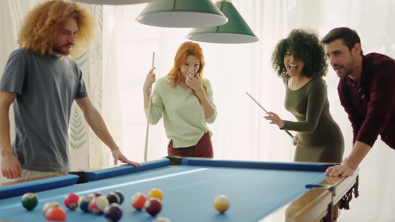 Beginner player hitting a billiard ball and laughing happy