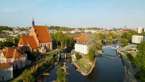 Aerial-View-Of-Brda-River-With-Bydgoszcz-Cathedral-By-The-Riverside-In-Poland-On-A-Sunny-Day