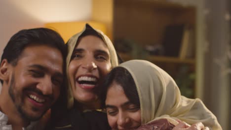 Loving-And-Happy-Muslim-Muslim-Family-Celebrating-Eid-Hugging-Each-Other-At-Home-3