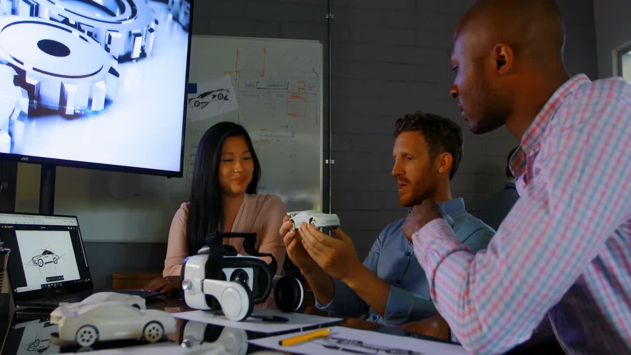 Business colleagues discussing over car model 4k