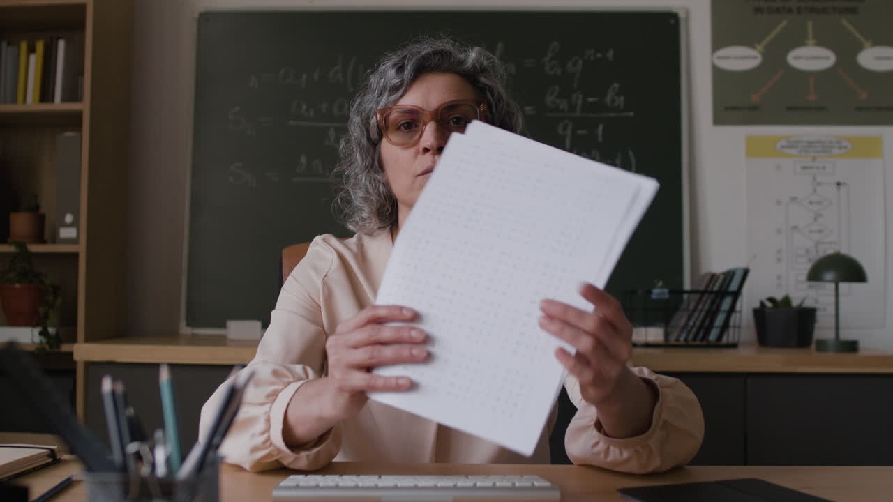 Teacher Presenting a Document in a Classroom